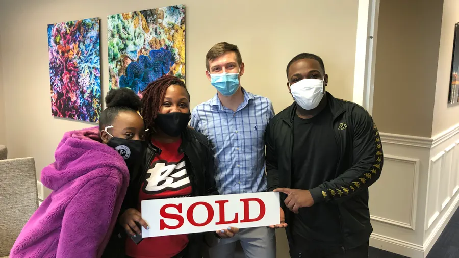 Spencer Lowe with Louisville clients on closing day